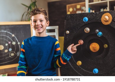 Happy School Boy Making A Solar System For A School Science Project At Home