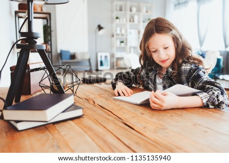 Similar – Image, Stock Photo happy school girl doing homework. Smart child working hard