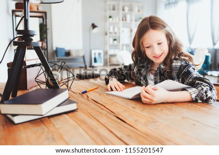 Similar – Image, Stock Photo happy school girl doing homework. Smart child working hard