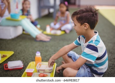 Happy schoolboy having meal in school - Powered by Shutterstock