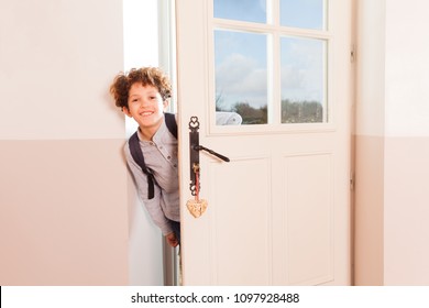 Happy Schoolboy Looking Through The Doorway