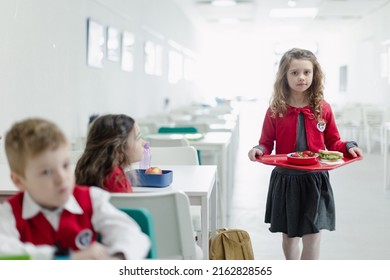 Happy Schoolgrirl In Uniform Holding Tray With Lunch In School Canteen.