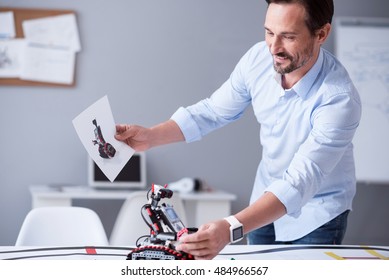 Happy Scientist Holding A Prototype Of His Invention