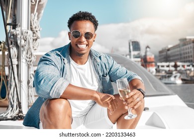 Happy, Sea And Man On A Luxury Yacht Or Catamaran Enjoying A Glass Of Champagne On A Summer Holiday Alone. Lifestyle, Smile And Young Person In Sunglasses Drinking Wine On Cruise Boat To Relax At Sea