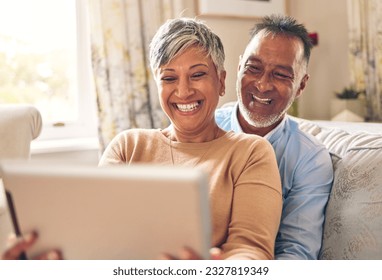 Happy, selfie and a couple with a tablet on the sofa for communication, social media or online chat. Smile, house and a senior man and woman taking a photo on technology on the couch and laughing - Powered by Shutterstock