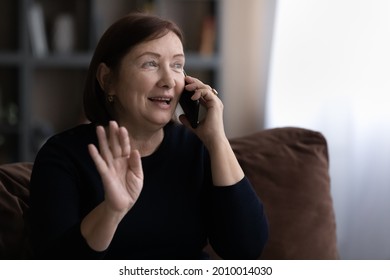 Happy Senior 60s Woman Talking On Mobile Phone, Making Call From Home, Speaking To Family On Smartphone, Smiling. Middle Aged Mature Lady Consulting Doctor On Cellphone, Making Order