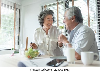 Happy Senior adult couple eating healthy salad together. Lovely Grandmother feeding to her Grandfather. Lover, Retirement, Wellness. BeH3althy - Powered by Shutterstock