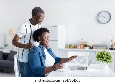 Happy Senior African American Couple Looking At Laptop During Video Chat