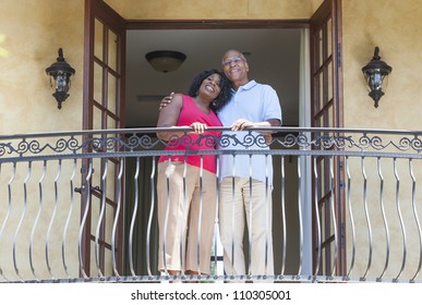 A Happy Senior African American Man And Woman Couple In Their Sixties Outside Together Smiling On A Hotel Or Villa Balcony