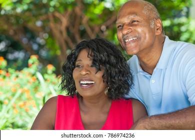 A Happy Senior African American Man And Woman Couple In Their Sixties Outside Together Smiling.