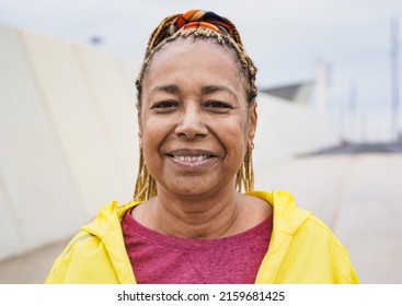 Happy Senior African Woman Smiling On Camera After Sprot Workout In The City During Rainy Day