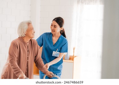 Happy Senior Asian Woman Receives Medical Care at Home, Doctor or Caregiver Nurse Provide Support Assistance, Enhancing Healthcare Services for Elderly Patients Retirement - Powered by Shutterstock