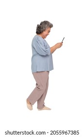 Happy Senior Asian Woman Typing On Mobile Phone And Walking Isolated On White Background, Full Body Composition