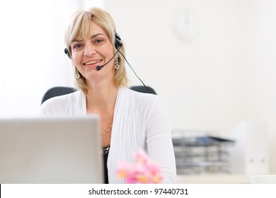 Happy Senior Business Woman With Headset Working On Laptop