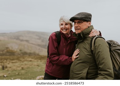 Happy senior camping couple, outdoor travel. Senior couple enjoying the British countryside. Nature walk for retired couple. Seniors and wellness, hiking in beautiful nature. - Powered by Shutterstock