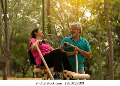 happy senior citizen couple doing exercise in park