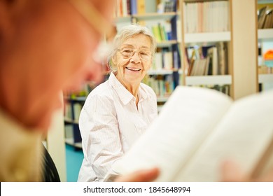 Happy Senior Citizen In A Library At The Retirement Home Enjoys Further Education