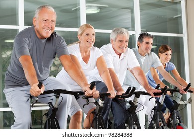 Happy Senior Citizens Exercising In Class In Fitness Center