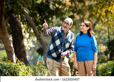 Happy senior couple admiring view at park - Powered by Shutterstock