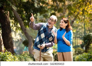 Happy senior couple admiring view at park - Powered by Shutterstock