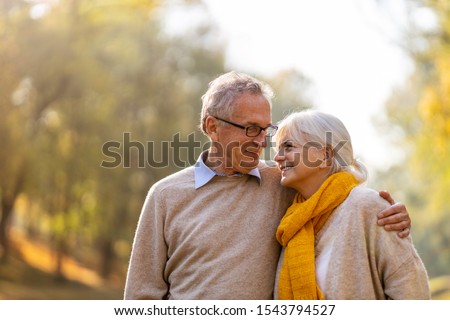 Happy senior couple in autumn park
