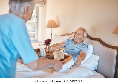 Happy, senior couple and bed with breakfast for meal, snack or food for anniversary or morning at home. Elderly, man and woman with woodren tray of bread, snack or nutrition for room service at house - Powered by Shutterstock