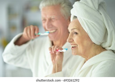 Happy Senior Couple Brushing Teeth