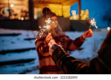 Happy senior couple celebrating new year with sparklers, enjoying winter evening. - Powered by Shutterstock