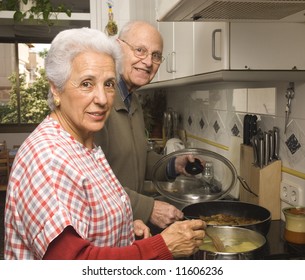 Happy Senior Couple Cooking At Home