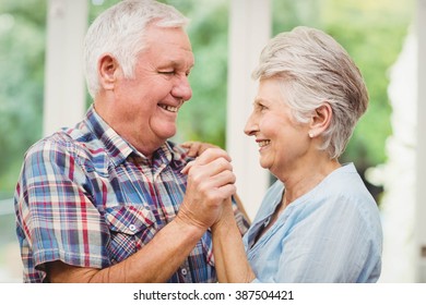 Happy Senior Couple Dancing At Home