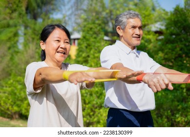 happy senior couple doing elastic band exercise, concept stretch exercise for rehabilitation muscles in older adult - Powered by Shutterstock