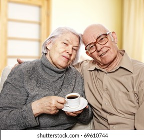 Happy Senior Couple Drinking Coffee At Home