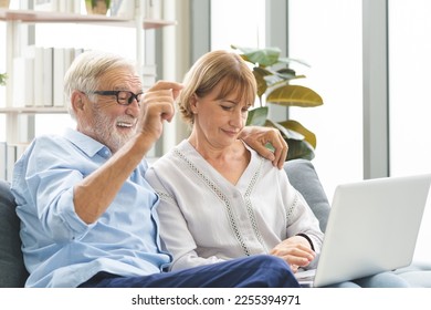 Happy senior couple, elderly family, caucasians mature, adult lover and retired man, woman using laptop computer shopping online, reading news on sofa at home together. Husband and wife lifestyle. - Shutterstock ID 2255394971