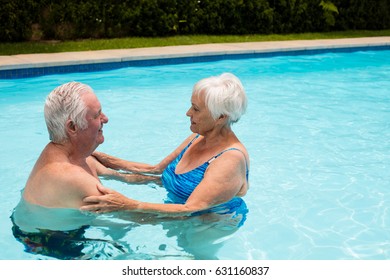 Happy senior couple embracing each other in the pool - Powered by Shutterstock