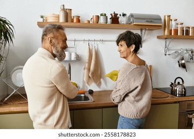 A happy senior couple enjoys washing dishes together in their cozy kitchen. - Powered by Shutterstock