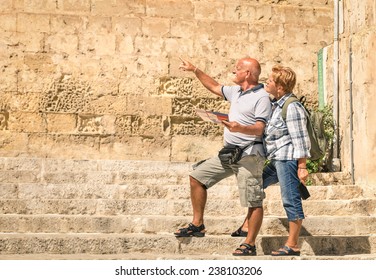 Happy Senior Couple Exploring Old Town Of La Valletta With City Map - Concept Of Active Elderly And Travel Lifestyle Without Age Limitation - Trip To European Mediterranean Wonders