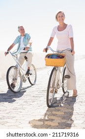 Happy Senior Couple Going For A Bike Ride On A Sunny Day