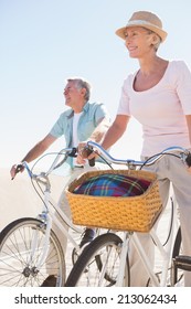 Happy Senior Couple Going For A Bike Ride On A Sunny Day