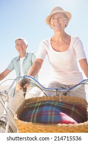 Happy Senior Couple Going For A Bike Ride On A Sunny Day