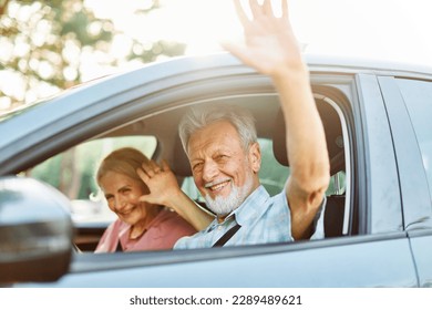 Happy senior couple going on a trip in their car - Powered by Shutterstock