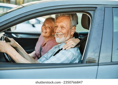 Happy senior couple going on a trip in their car - Powered by Shutterstock