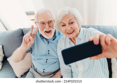 Happy Senior Couple Having Fun And Taking Photograph On Mobile Phone To Share Online On Social Networks - Elderly People Using Modern Technology, Grandparents Taking Selfie