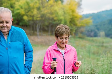 Happy Senior Couple Having Fun Hiking Outdoor In The Mountain Forest - Soft Focus Woman Face.