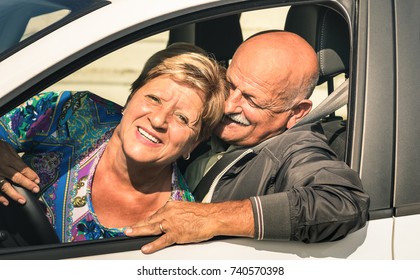 Happy Senior Couple Having Fun Driving Car Trip On The Road - Joyful Active Elderly Concept With Retired Man And Woman Enjoying Best Years - Modern Mature Travel Lifestyle On Retirement Time Mood