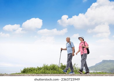 Happy Senior couple hiking together on the mountain and coast - Powered by Shutterstock