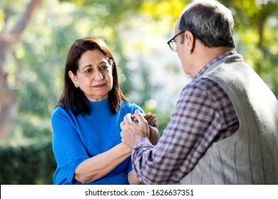 Happy senior couple holding hands at park - Powered by Shutterstock