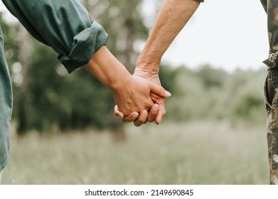 happy senior couple holding hands. hands of man and woman hold each other. romance and love and support in elderly family. faceless husband and wife travel together in nature. people countryside life