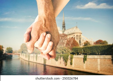 Happy Senior Couple Holding Hands Against Notre Dam In Paris