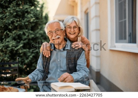 Happy senior couple at independent living community looking at camera. Copy space.
