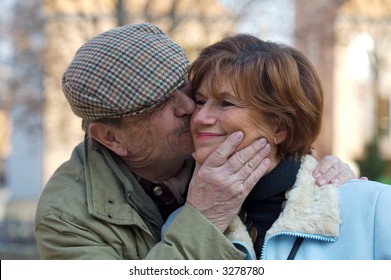 Happy Senior Couple Kiss Each Other.